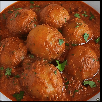 Spicy Kashmiri dum aloo featuring tender baby potatoes slow-cooked in a rich, vibrant yogurt curry sauce
